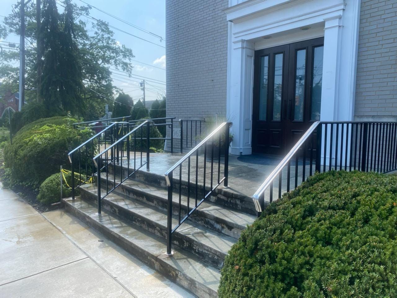 A set of stairs leading up to a building with a railing.