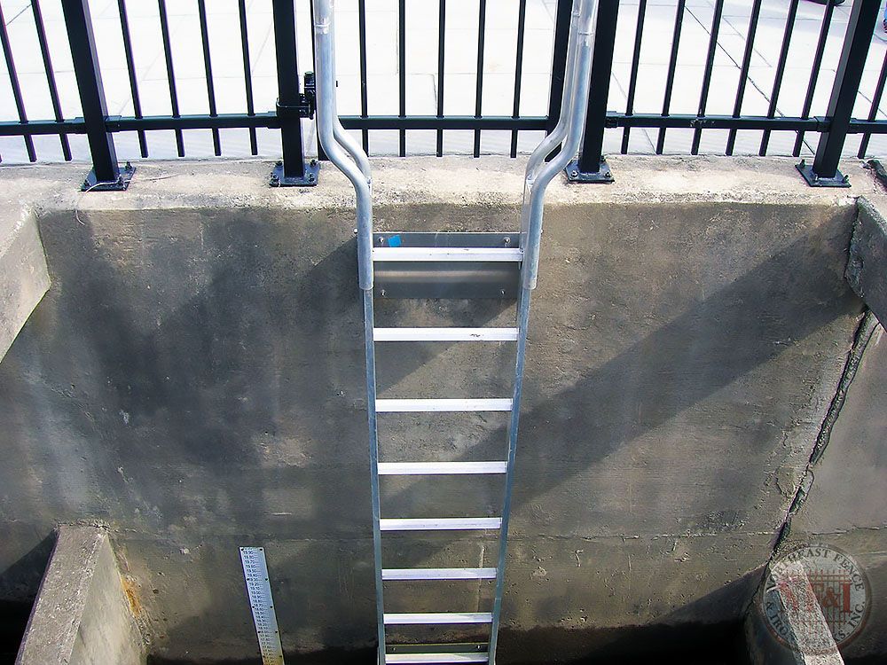 A metal ladder is attached to a concrete wall