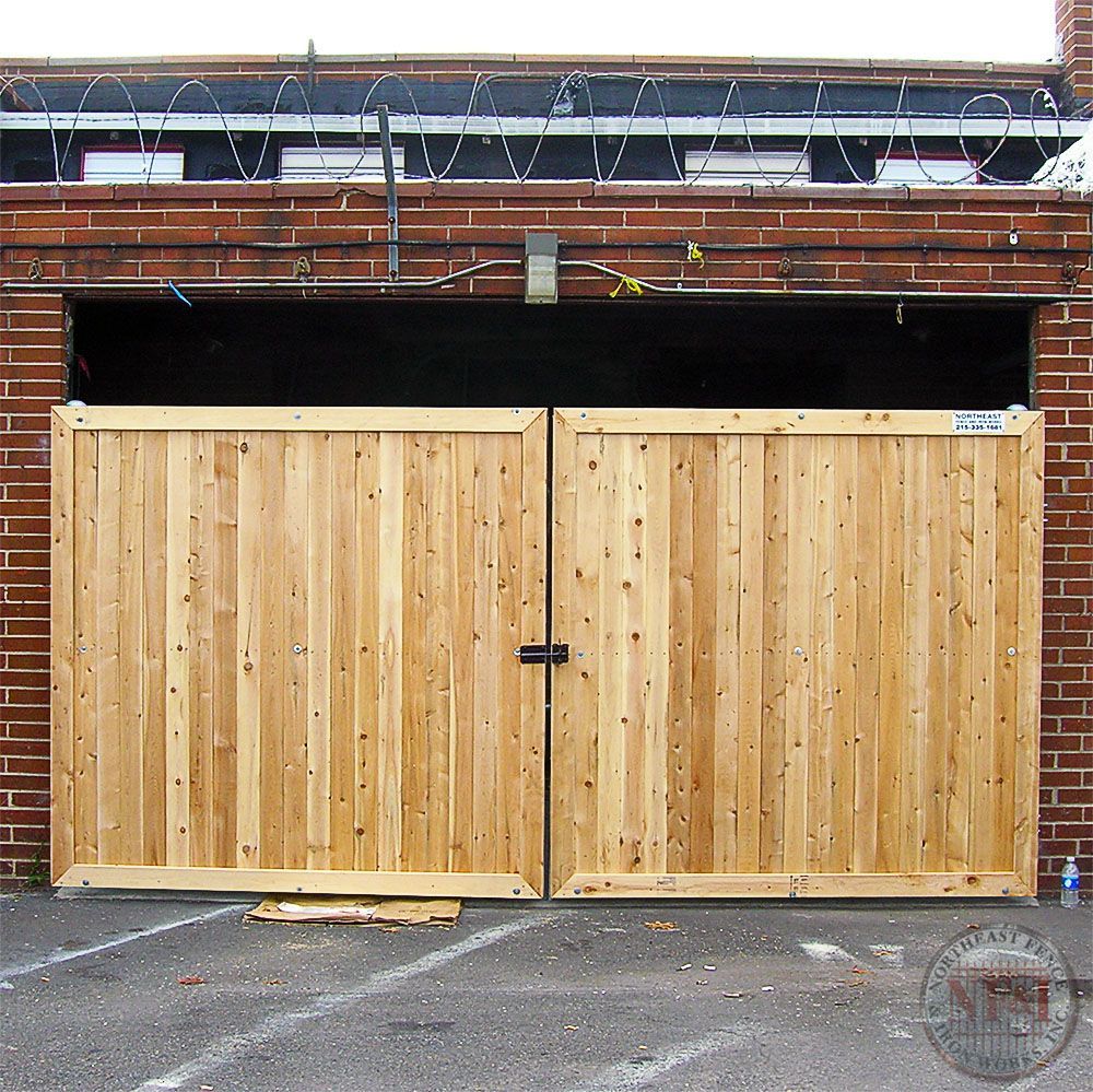 A brick building with a wooden gate in front of it