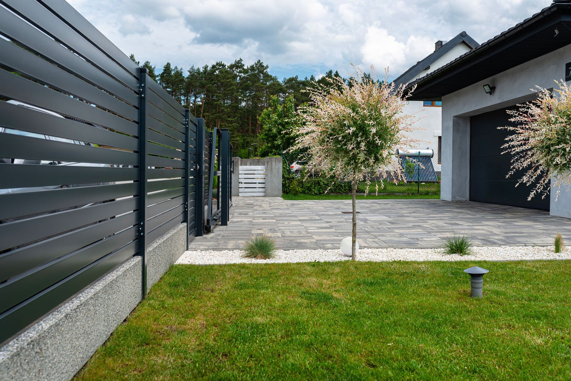 A modern panel fence installation at a residential property. A modern panel fence installation at a residential property.
