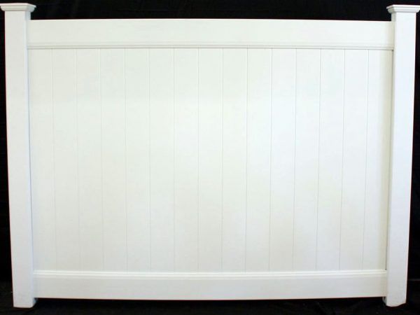 A white fence is sitting on a black surface.