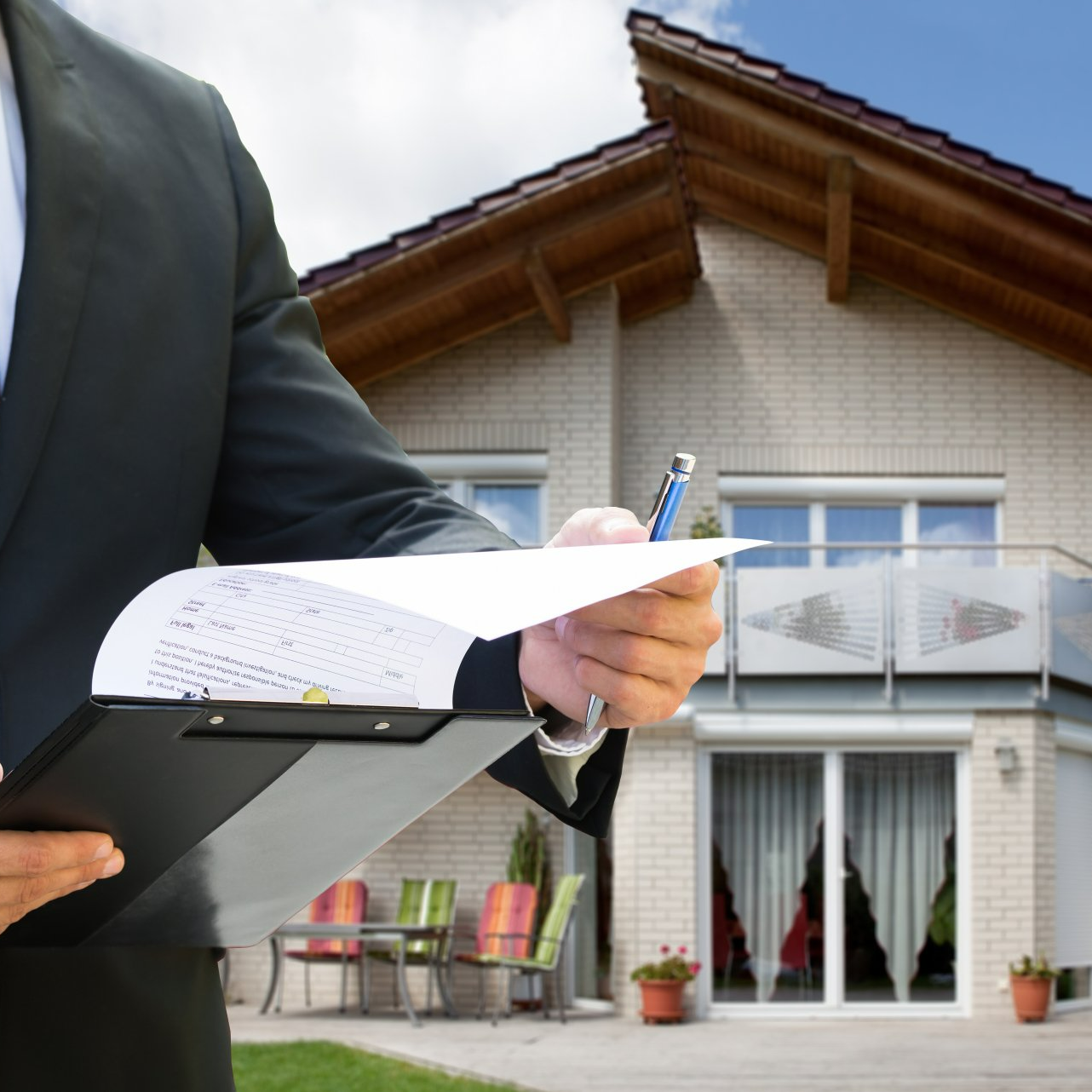 Man Checking Documents Standing Near House — Brookfield, WI — Horizons Law Group LLC
