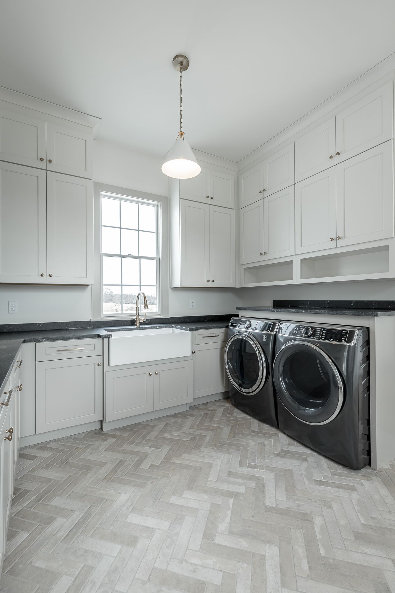 A laundry room with a washer and dryer and a sink.