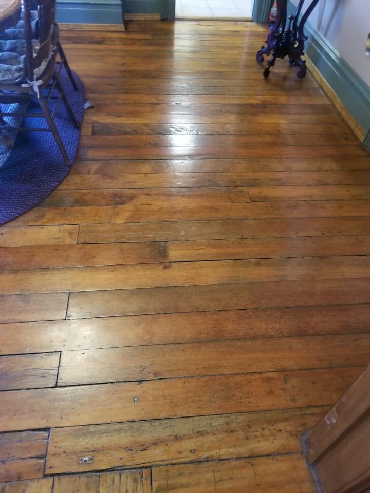 Wooden hallway floor with glossy planks and blue walls