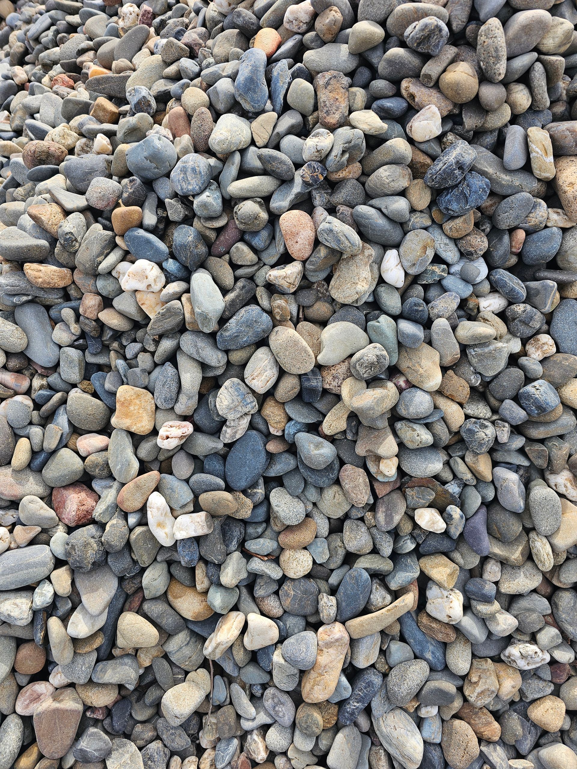 Pile of mixed-colour river rocks, varying in size and shape - Palms Landscape Supplies in Forster, NSW