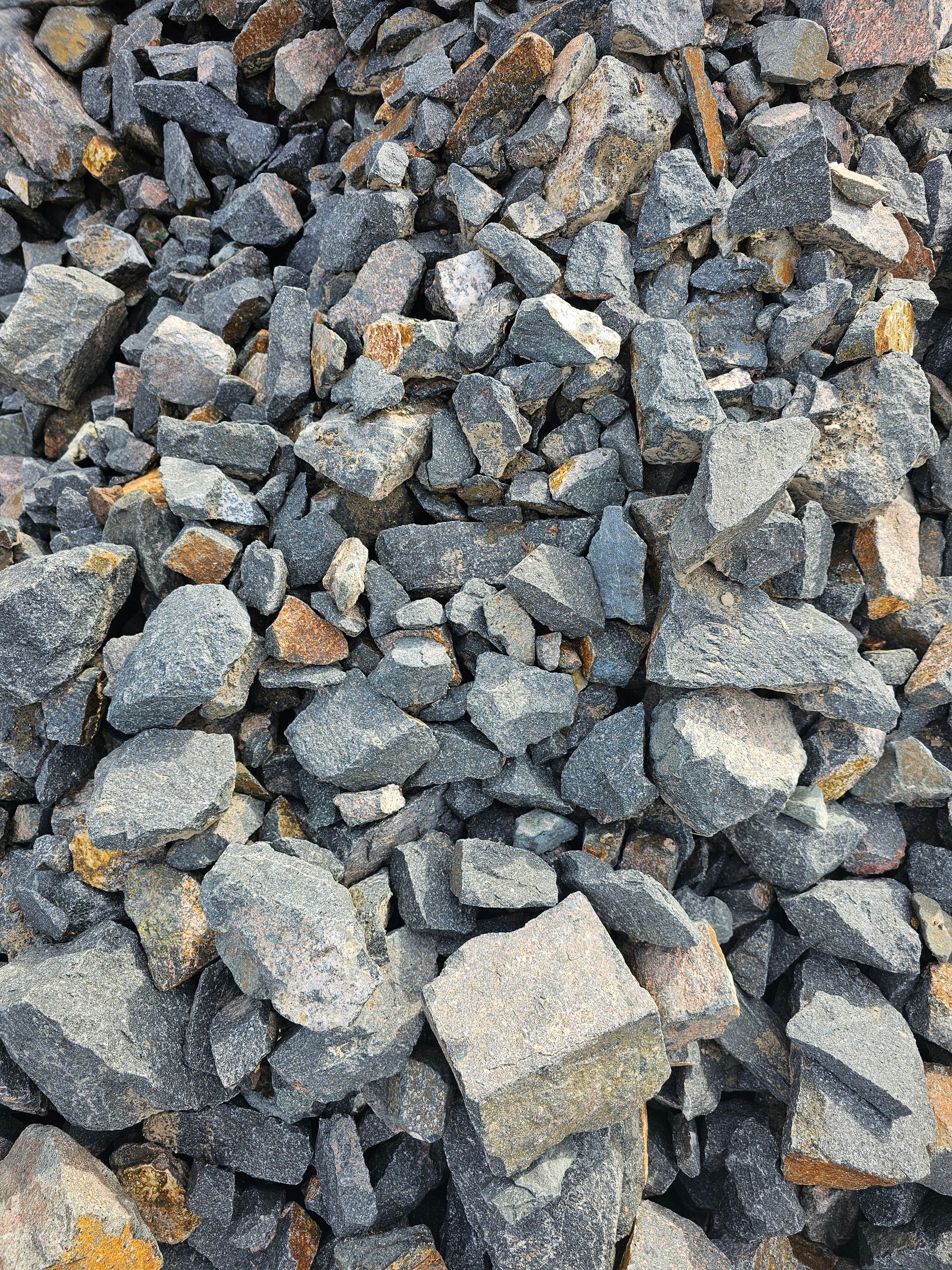 Pile of broken asphalt with grey, tan, and orange fragments - Palms Landscape Supplies in Forster, NSW