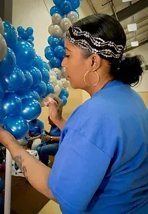 Girl Decorating Blue Balloons — Granger, IN — Make 'Em Pop Creations