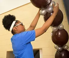 Girl Decorating Balloons — Granger, IN — Make 'Em Pop Creations