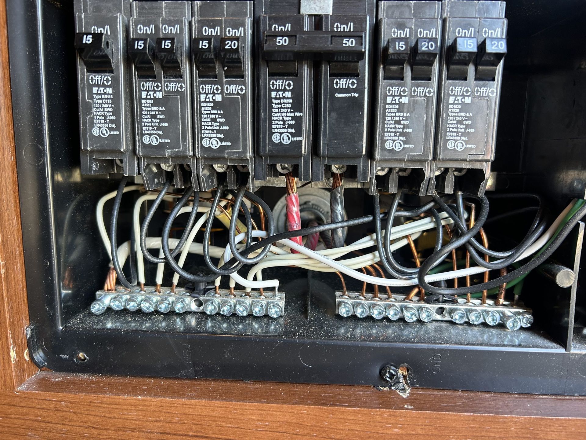 Electrical control panel with relays, wires, and terminal blocks inside a metal box
