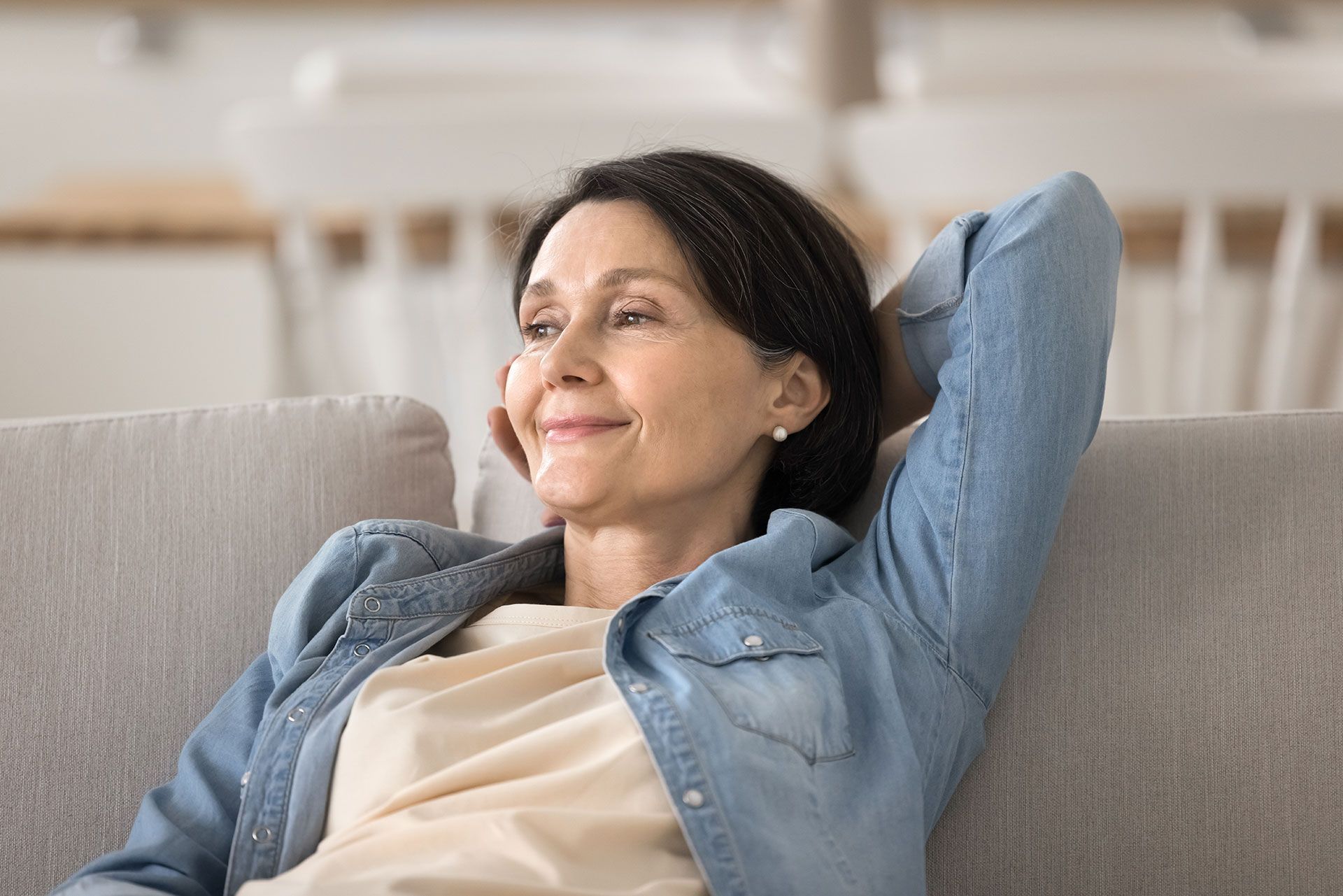 Smiling Woman Reclining on Sofa in Pensacola, FL