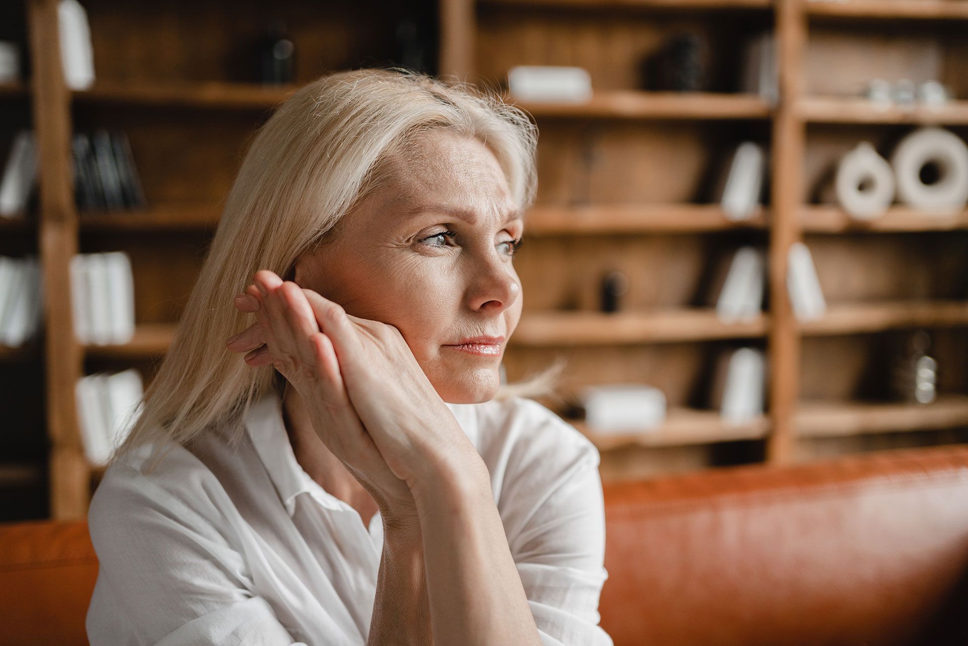 Woman With Clasped Hands, Experiencing Perimenopause Symptoms