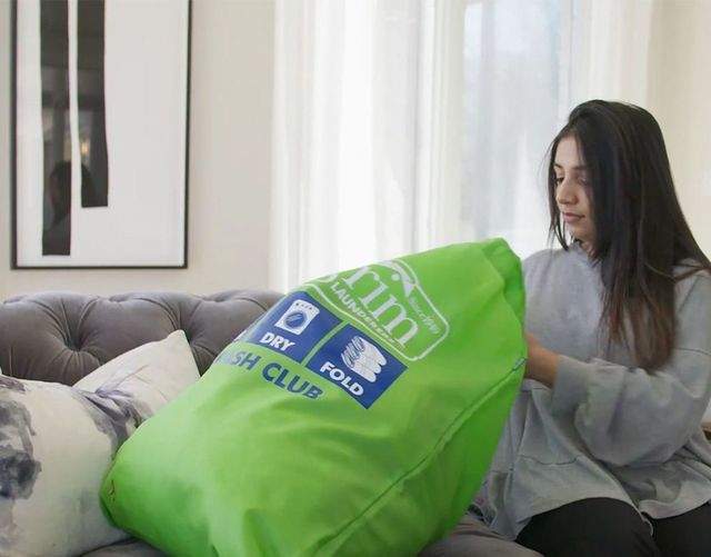 Woman putting clothing in Express bag