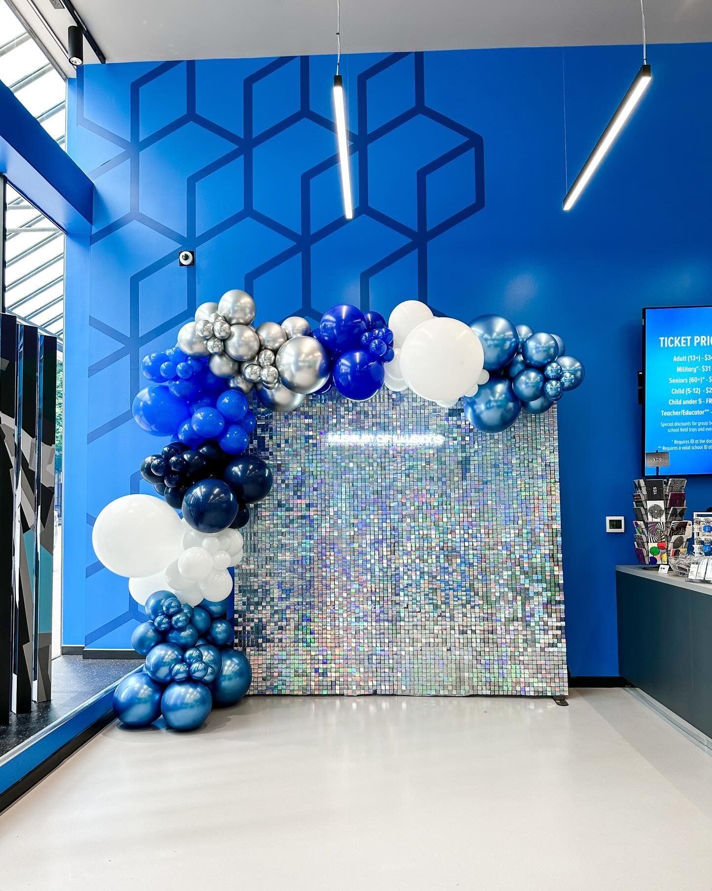 A room with a blue wall and balloons on it