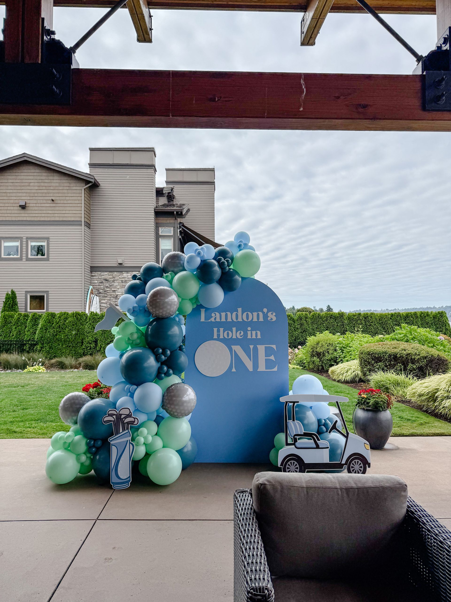 Blue arched backdrop with balloon garland for