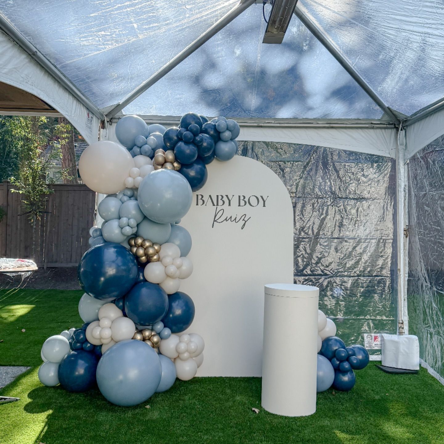A baby boy shower is being held under a tent.