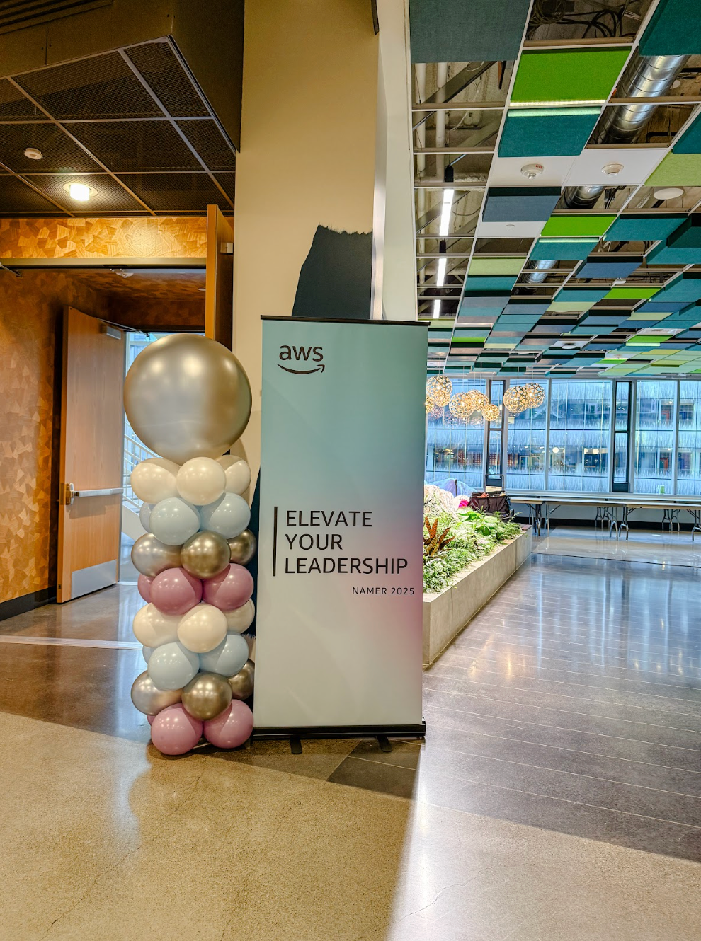 A stage with balloons and a sign that says `` grand opening '' in a grocery store.