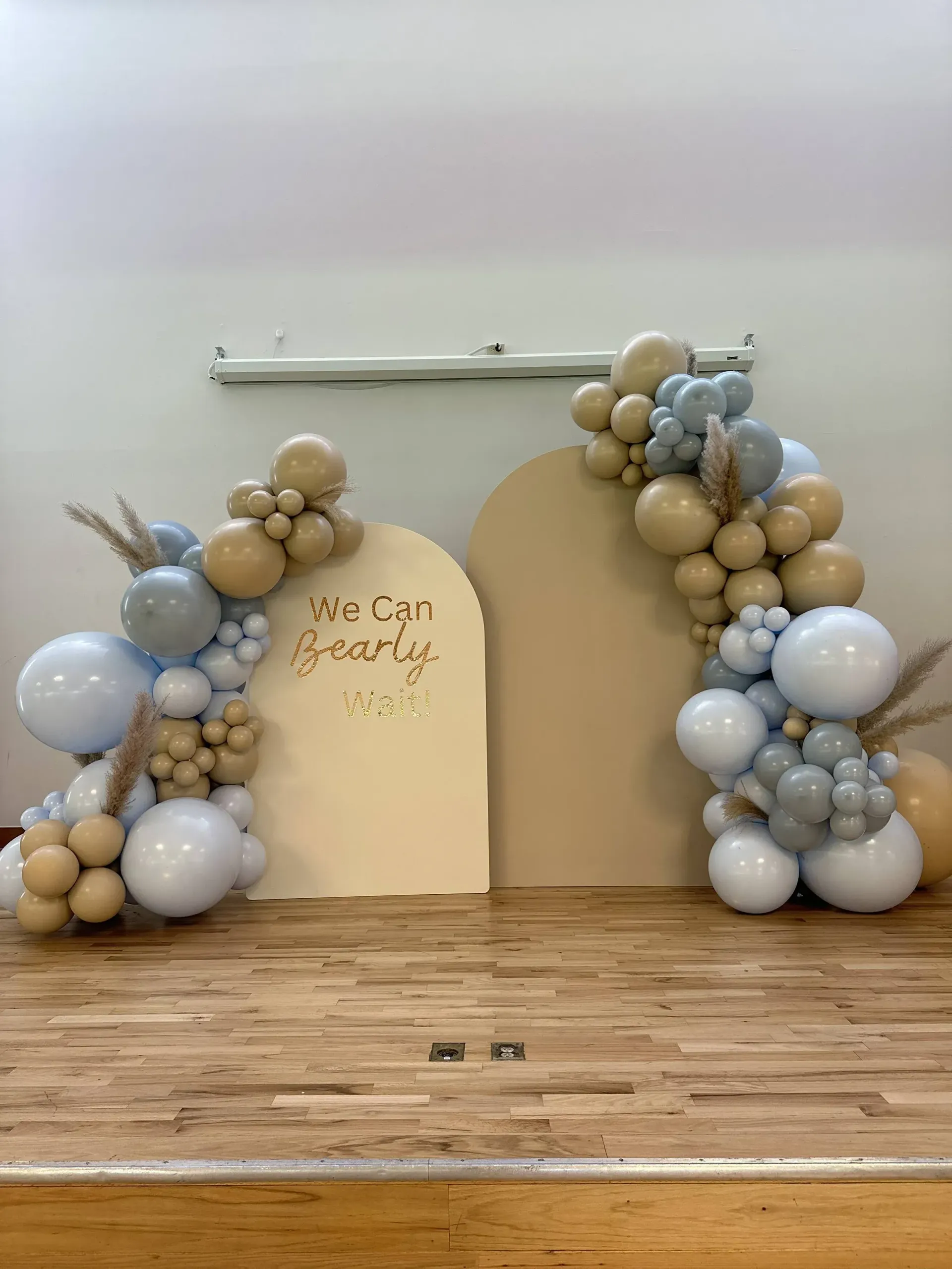 A bunch of balloons are sitting on top of a wooden floor.