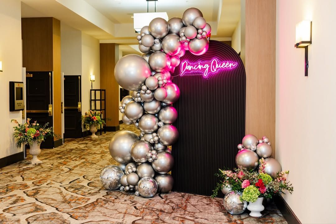 A room filled with balloons and smoke coming out of it.