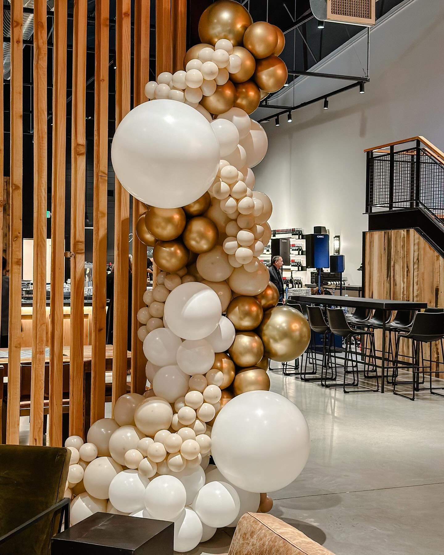 A bunch of balloons are hanging from the ceiling in a room