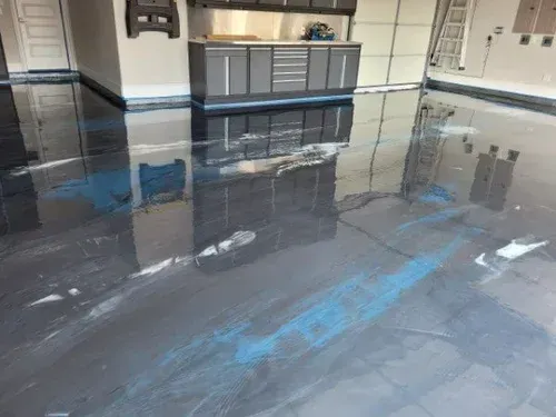 Explore a wide-angle view of a garage project, featuring a seamless silver metallic base coat elevated with striking ocean blue pearlescent waves.