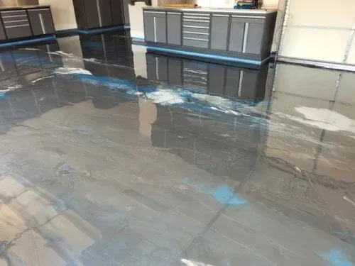 Explore a wide-angle view of a garage project, featuring a seamless silver metallic base coat elevated with striking ocean blue pearlescent waves.