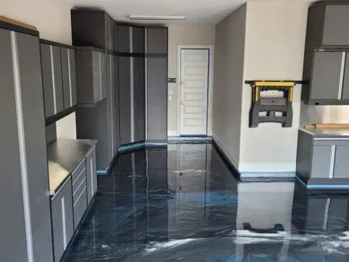 Explore a wide-angle view of a garage project, featuring a seamless silver metallic base coat elevated with striking ocean blue pearlescent waves.