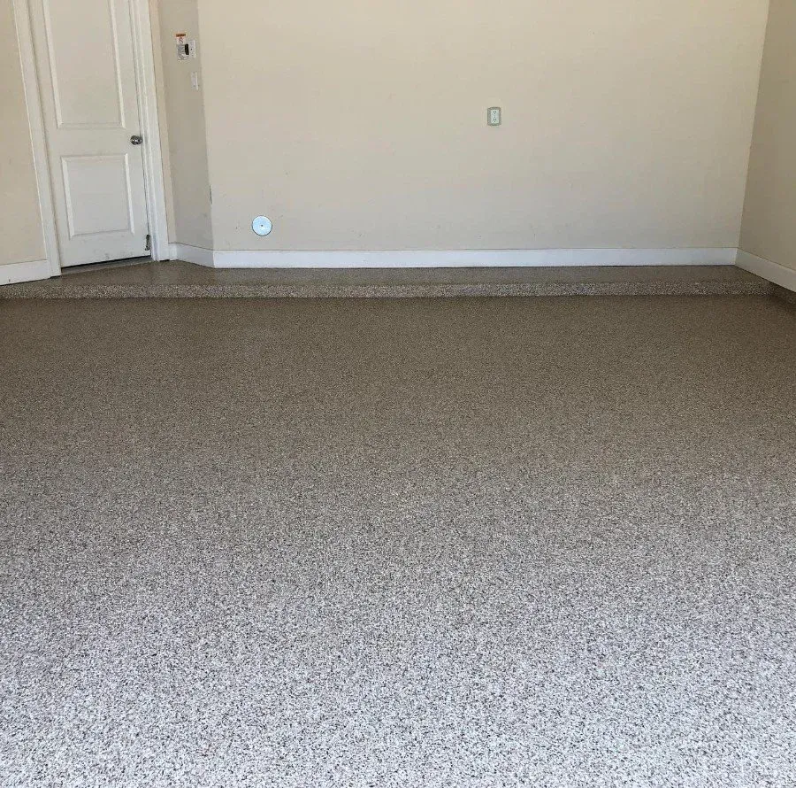 Empty beige-carpeted room with white walls and a closed door on the left
