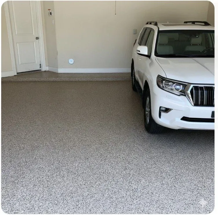 White SUV parked in a carpeted garage with a closed white door on the left.