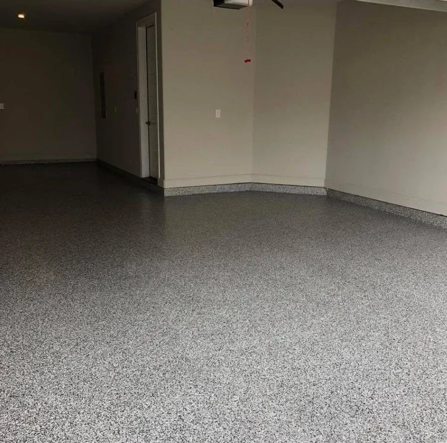 Empty carpeted room with beige walls, a doorway, and a central support column.