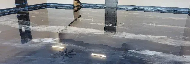 Explore a massive interior garage space featuring a high-gloss, mirror-like onyx metallic epoxy floor accented by shimmering silver veins in Metallic floor