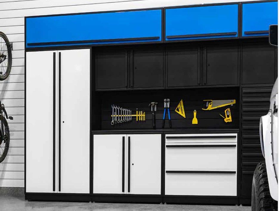 A stylish garage storage system designed by Global Garage Flooring & Design of Houston with black and white cabinetry, blue accents, and a fully equipped tool wall for efficient organization.