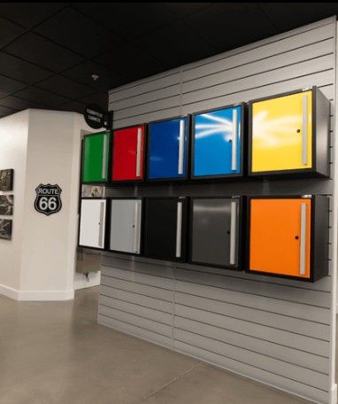 A modern showroom display featuring available ProSlat FusionPlus garage cabinet colors, helping homeowners visualize custom storage options.