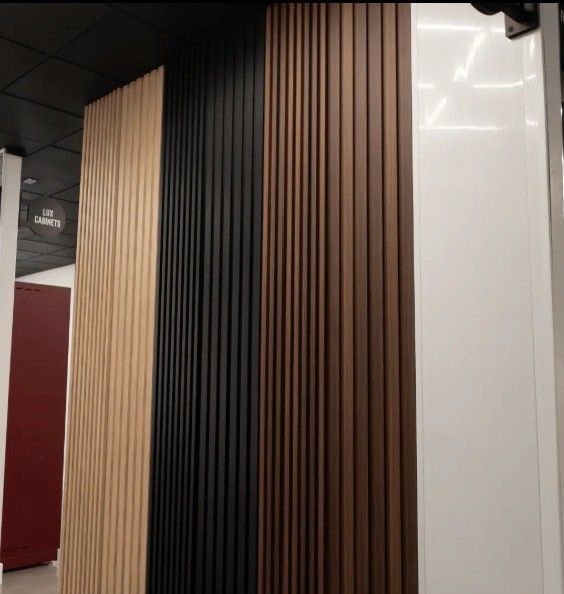 A showroom display featuring ProSlat Decorative Wall Panels in various wood tones, showcasing premium material options for modern interior design.
