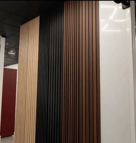 View a striking close-up display of ProSlat ProPanel finishes, showcasing modern light oak, matte black, rich walnut, and high-gloss white vertical wall panels.