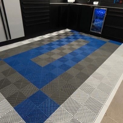 A geometric interlocking SwissTrax tile floor design featuring blue, gray, and white tones—durable, stylish, and ideal for modern garage upgrades.  Available from Global Garage Flooring & Design of Houston