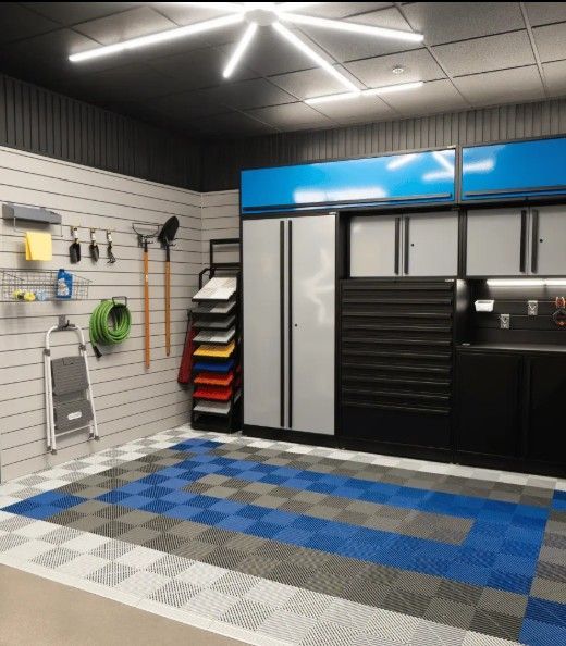 A fully organized garage featuring blue‑accented ProSlat FusionPlus cabinets, tool storage, and patterned interlocking tile flooring from SwissTrax for a premium workspace.