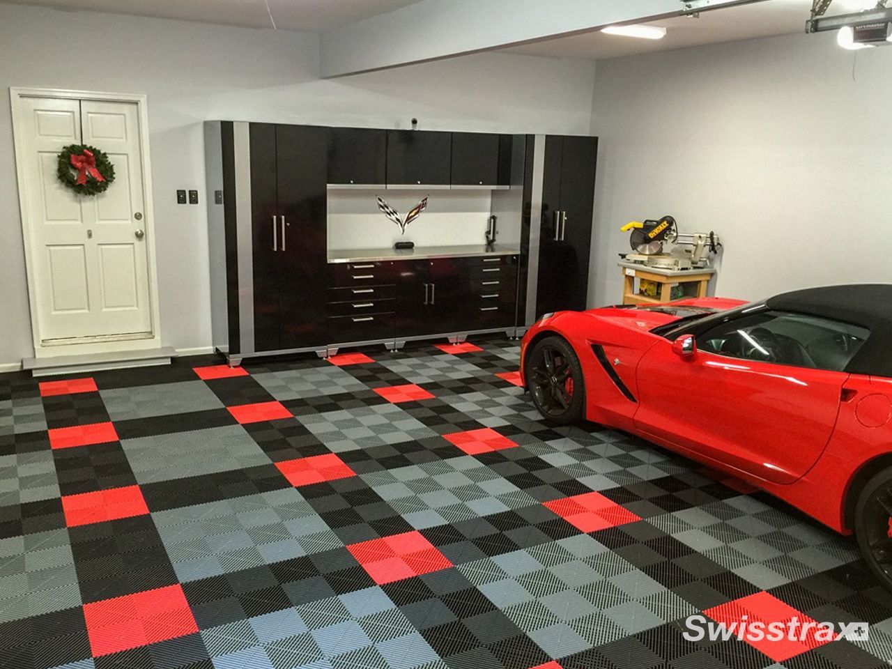 Look at a fully equipped home workshop and tool station in garage highlighted by a clean, seamless red, grey and black checkered SwissTrax interlocking floor.