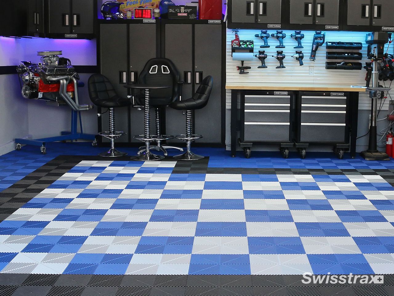 Look at a fully equipped home workshop and tool station in garage highlighted by a clean, seamless blue  and white checkered SwissTrax interlocking floor.
