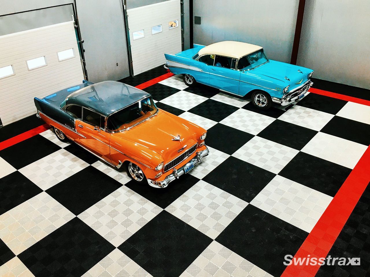 Check out a garage featuring  sleek automobiles parked over a premium  black, and white patterned SwissTrax interlocking tile floo