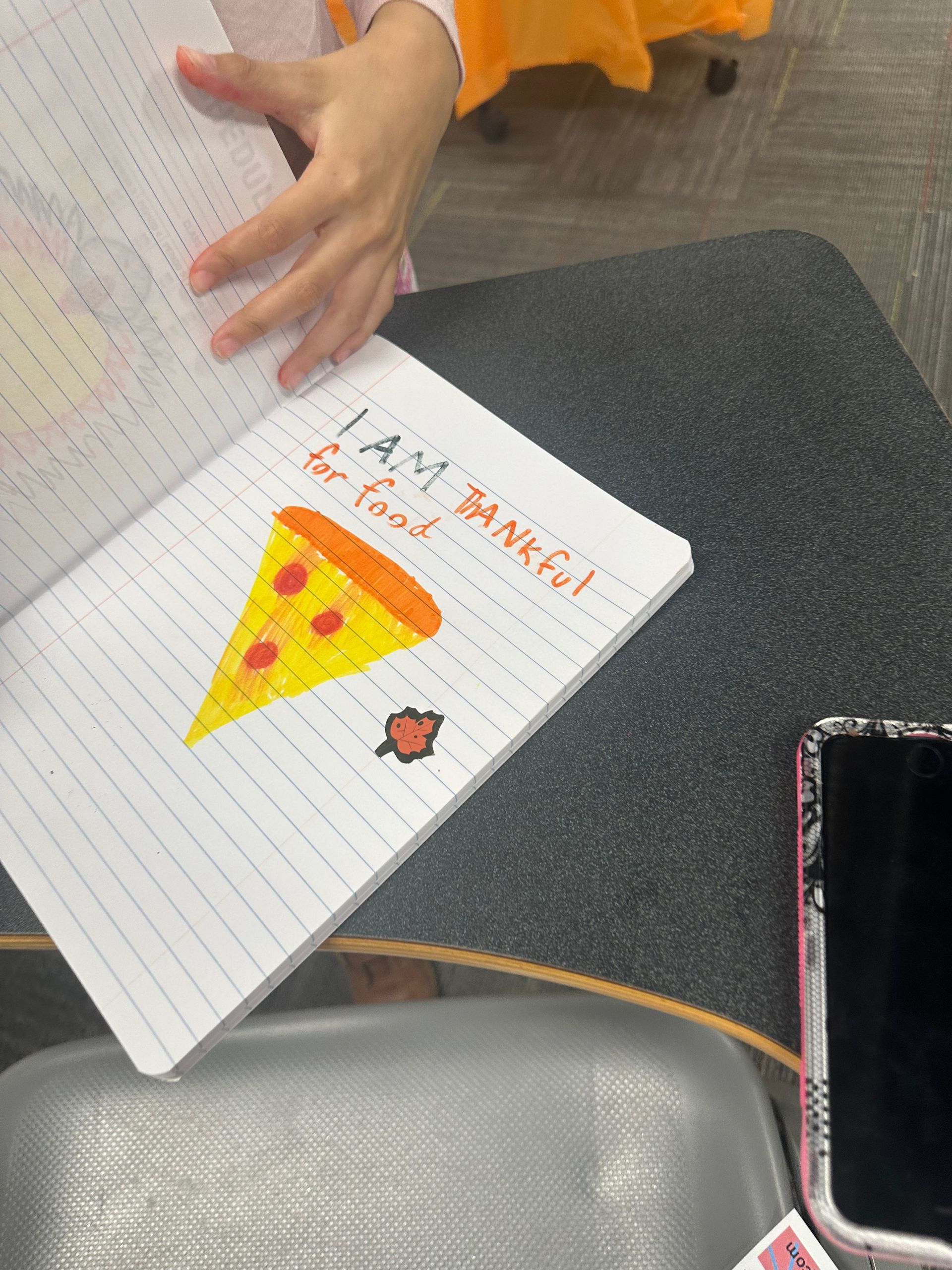 Notebook with pizza drawing and text