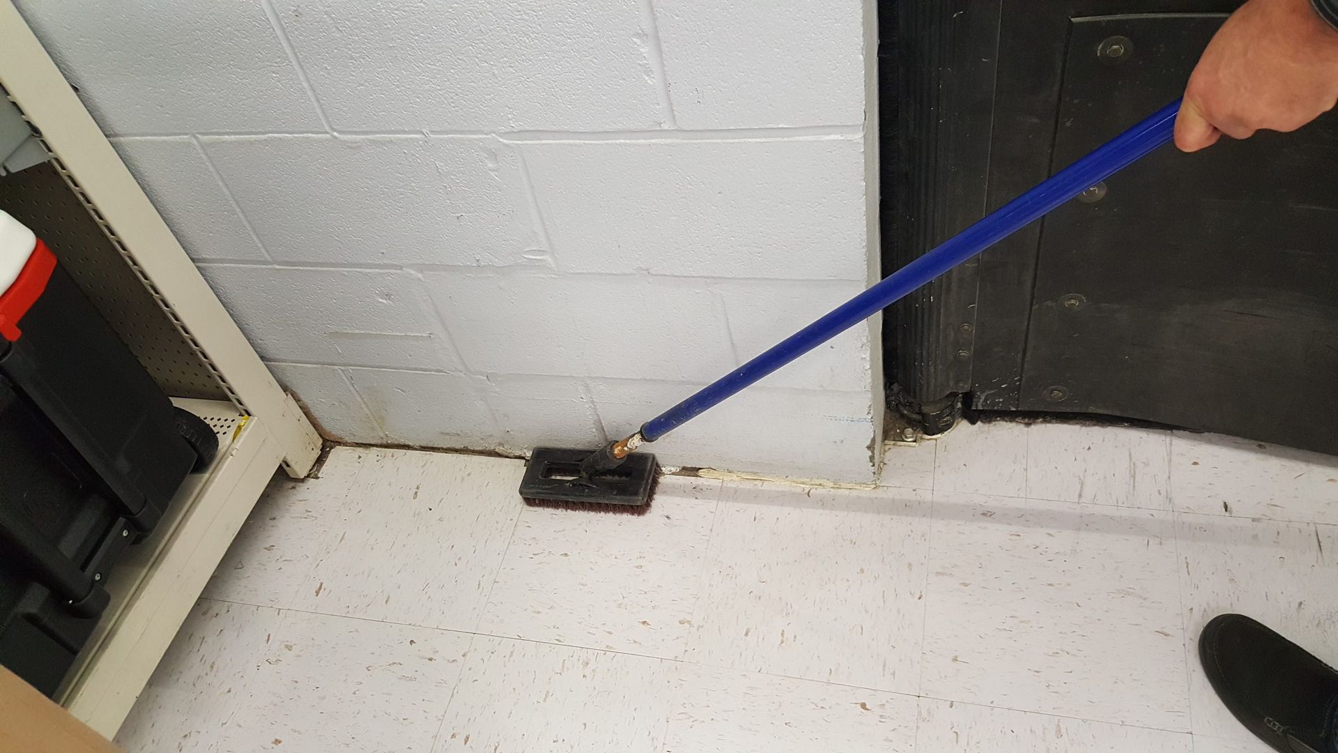 A person is cleaning the floor with a mop.