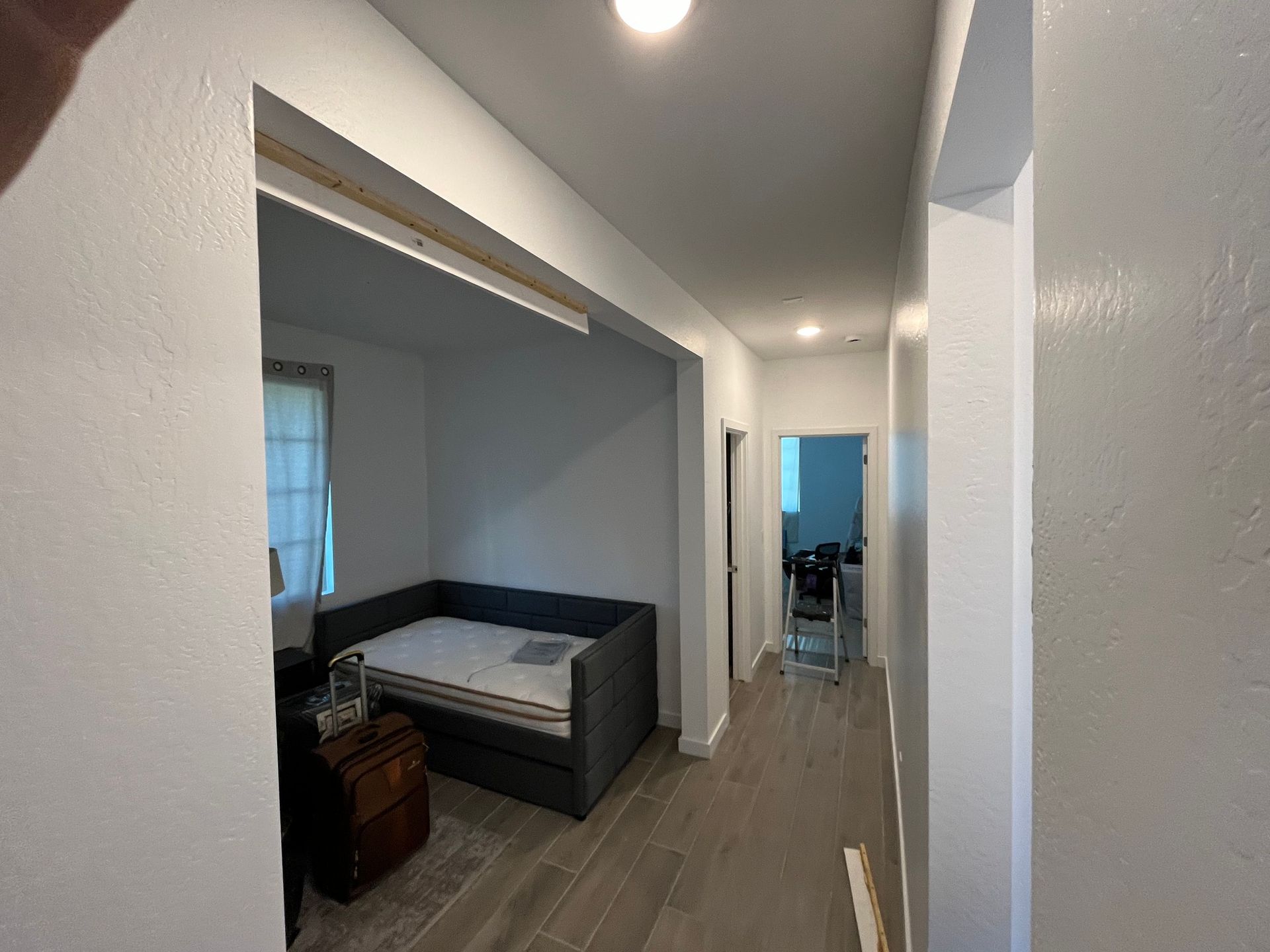 A hallway with a bed in the middle of it.