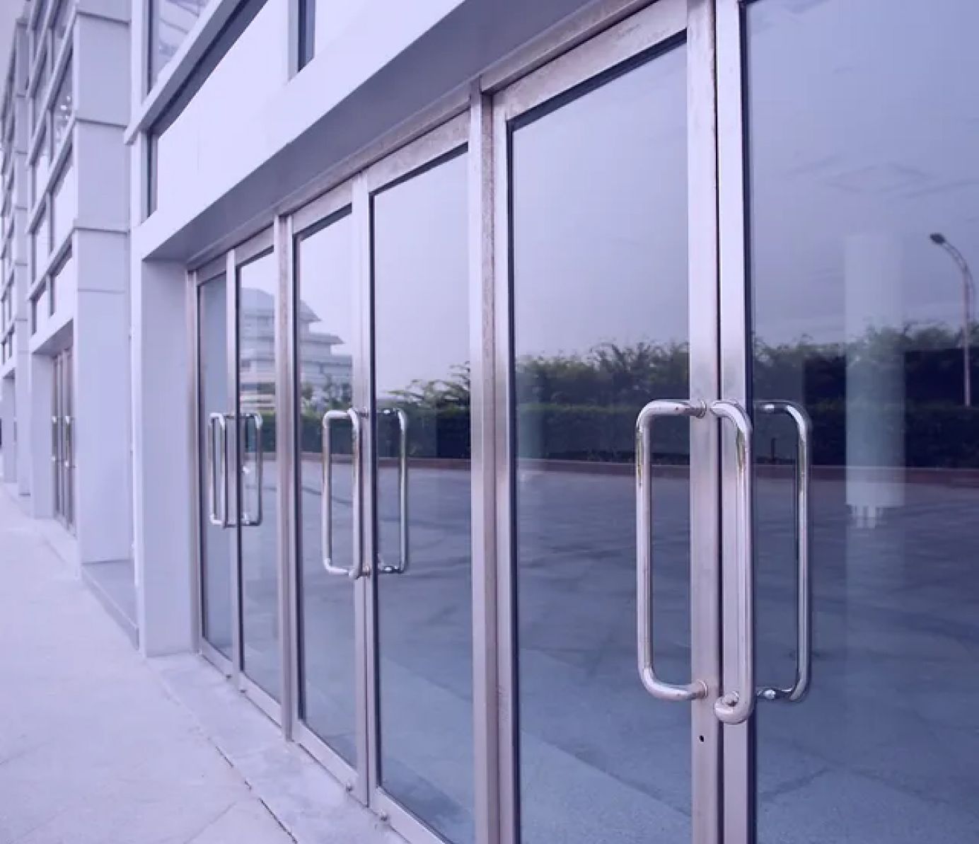 A building with a lot of glass doors and handles