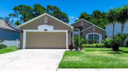 A house with two garage doors and a lush green lawn