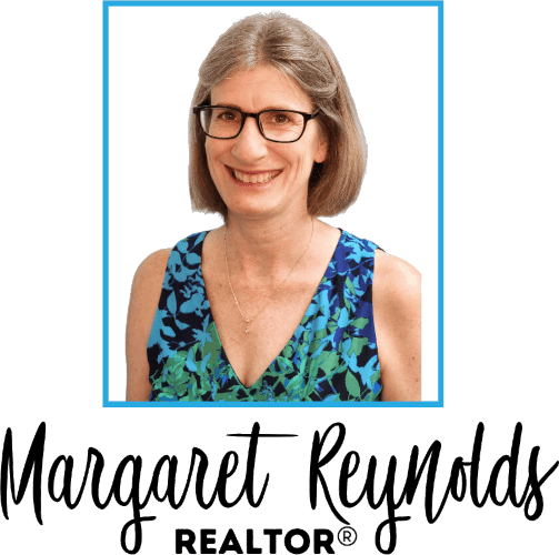 The logo for margaret reynolds realtor shows a woman wearing glasses and a blue top.