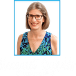 Margaret Reynolds wearing glasses and a blue and green dress