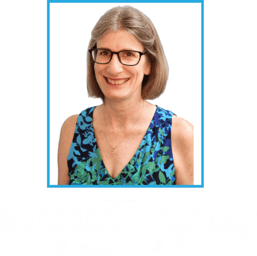 Margaret Reynolds wearing glasses and a blue and green dress