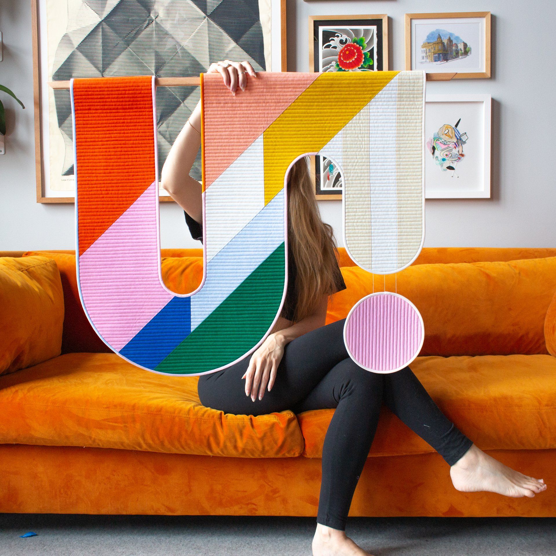 Emily holding a piece of her artwork