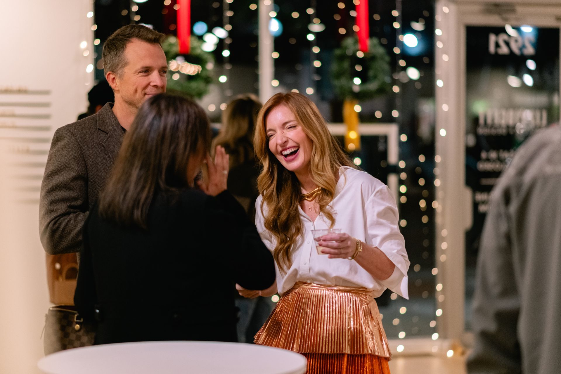 Liz chatting with guests and laughing