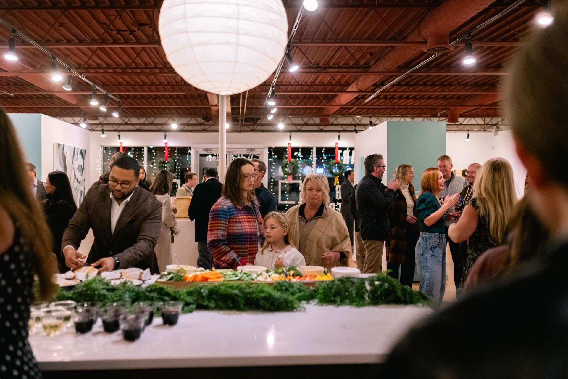 Full view of gallery and all the guests with tables cape in fore front